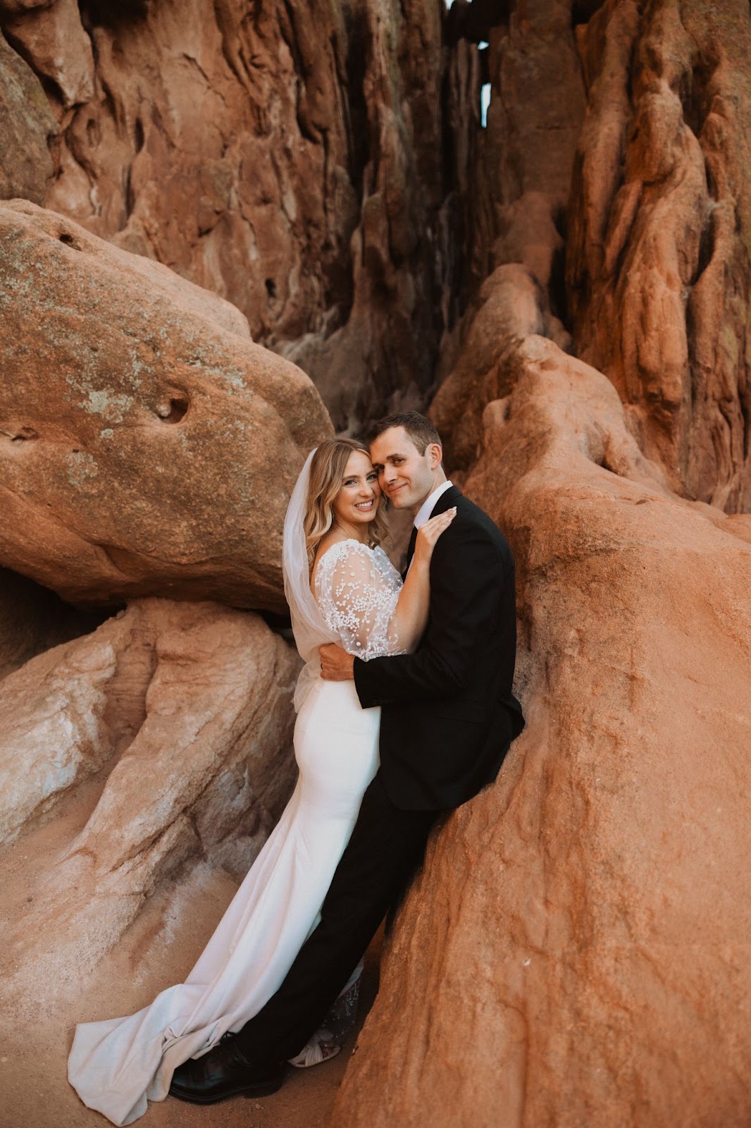 Bride and groom at Garden of the Gods smiling at camera