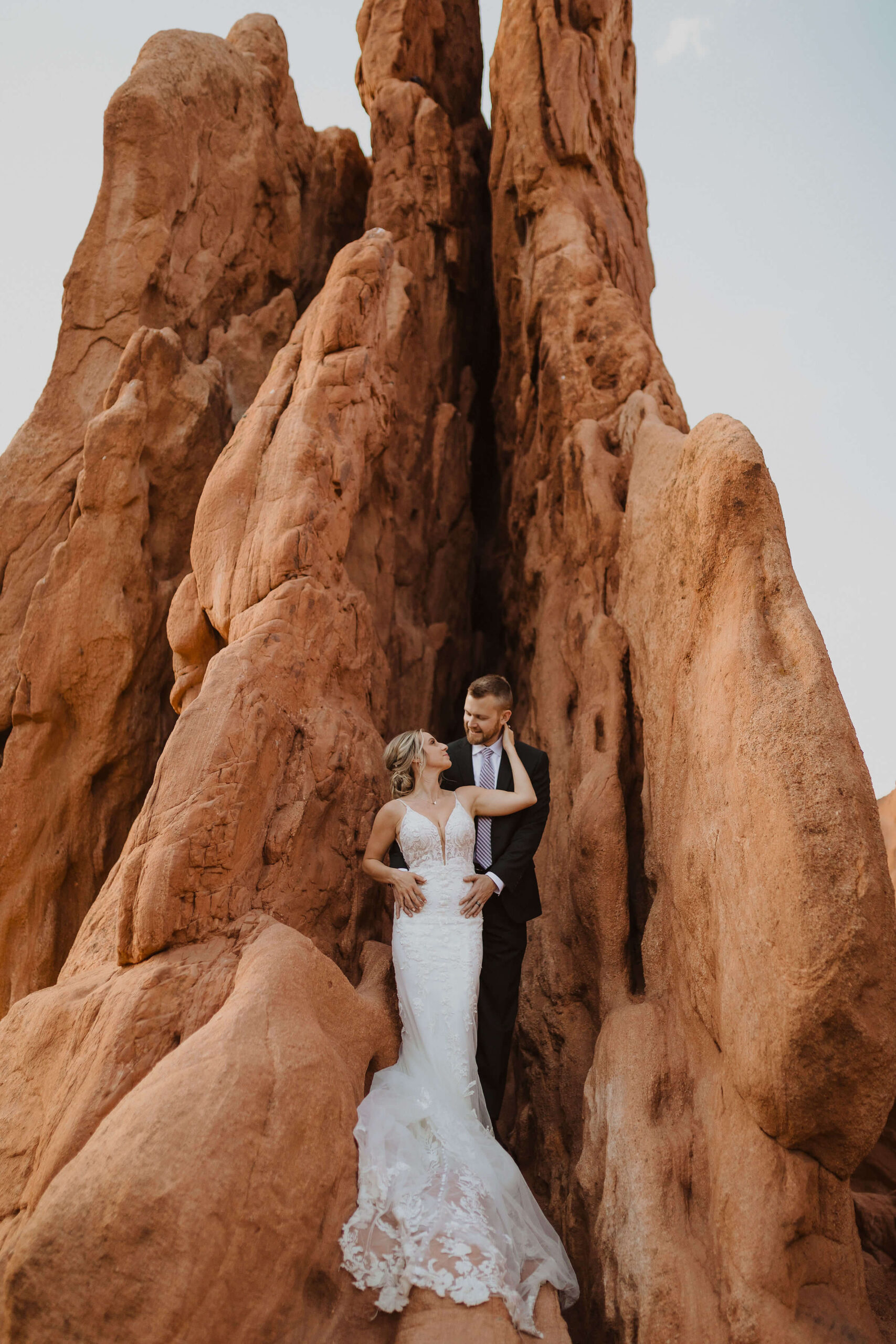 couple having Garden of the Gods elopement with red rock formation in the background