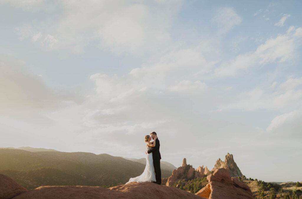 Bride and groom standing on rocks at Garden of the Gods