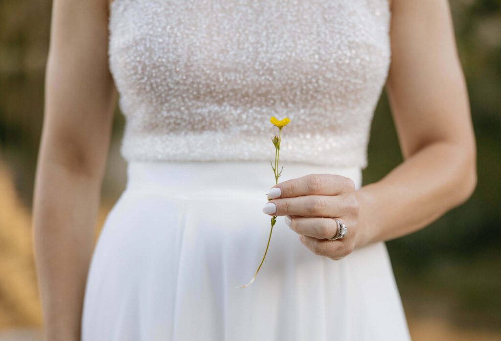 bride holding flower at Lake Isabelle elopement