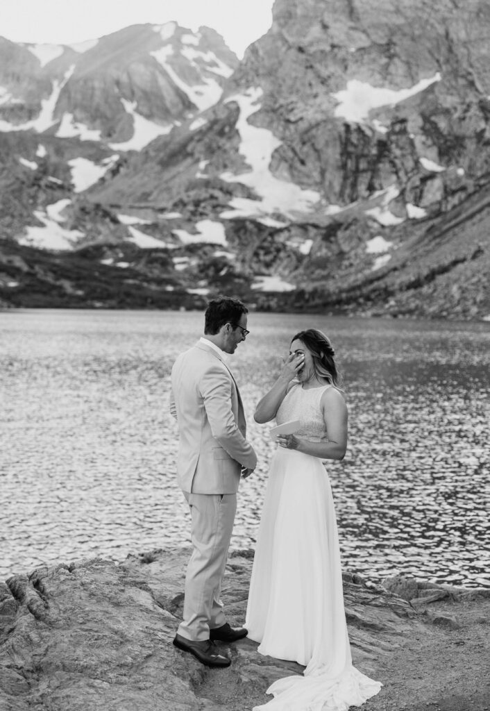 bride crying while reading her elopement vows at Lake Isabelle