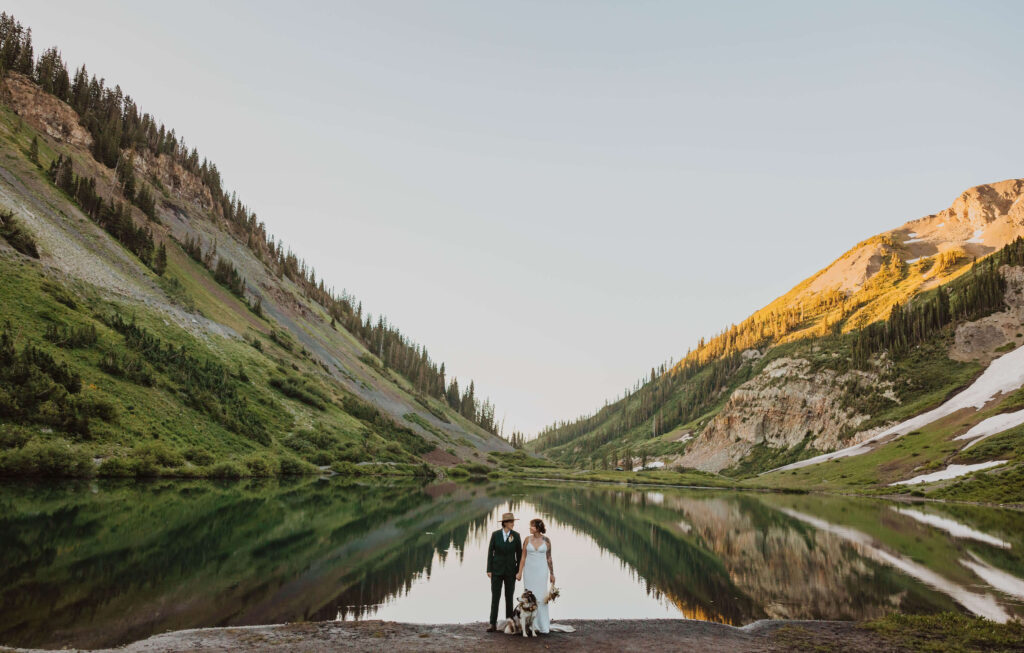 elopement couple with dog backed by mountains