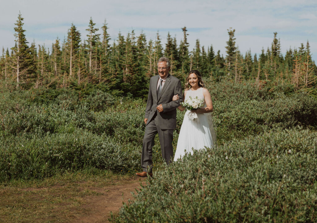 Dad walking bride surrounded by trees at Brainard Lake