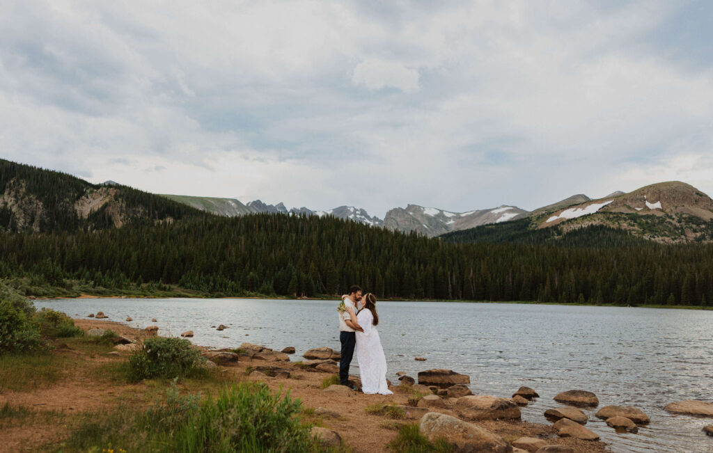 Bride and groom hugging next to Brainard Lake