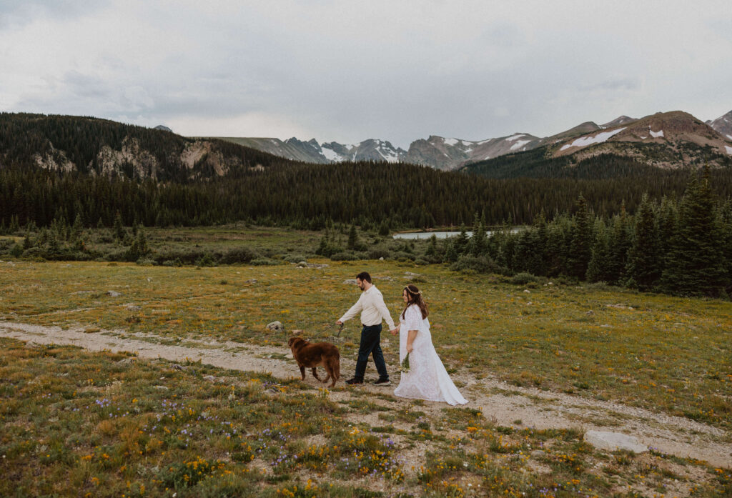 Bride and groom walking with dog at Brainard Lake