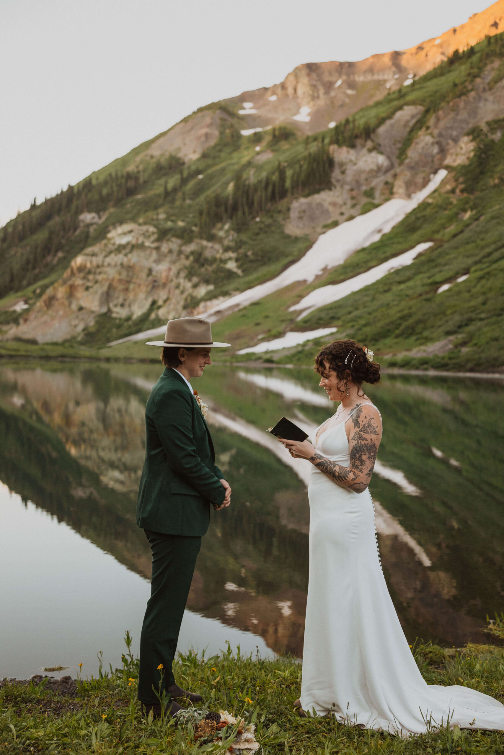 elopement couple reading vows in the mountains of Crested Butte