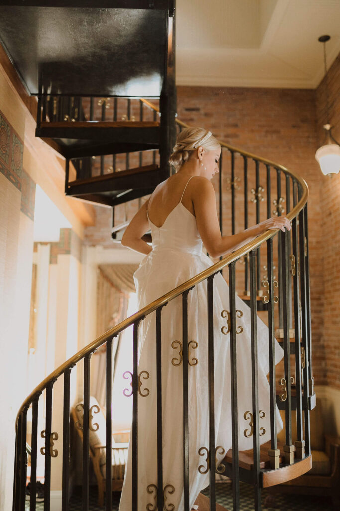 bride walking up stairs at Beaumont Hotel & Spa for elopement pictures
