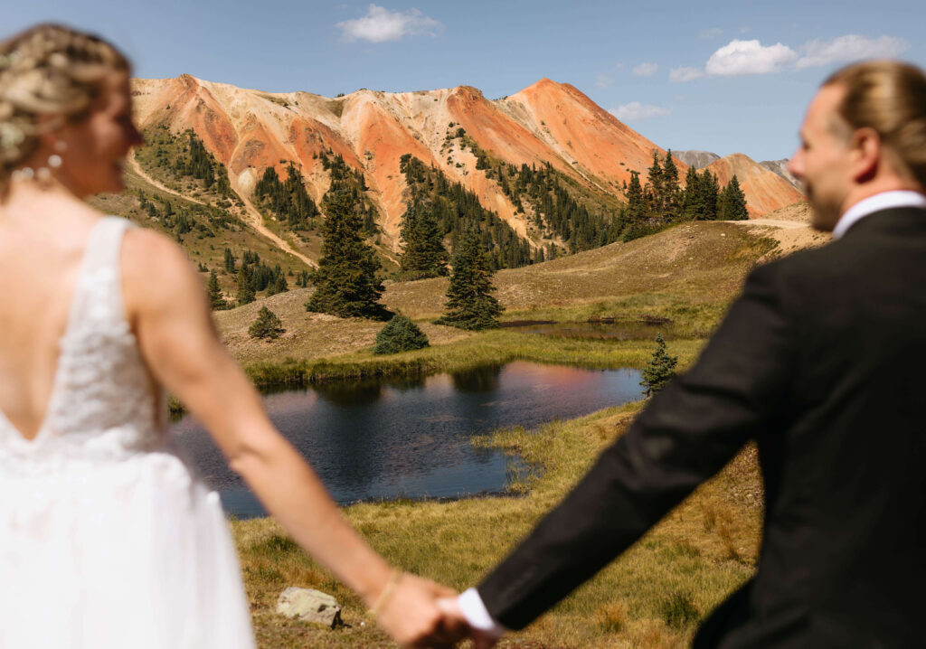 elopement couple looking at mountain scenery in Ouray, Colorado