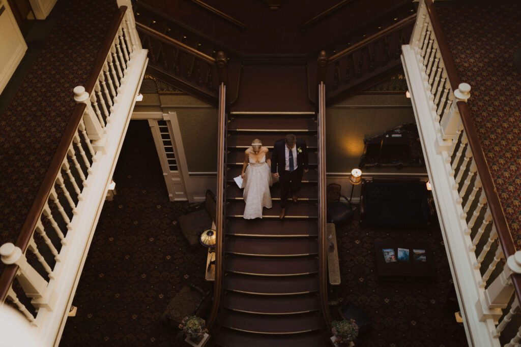 bride and groom walking down steps at Beaumont Hotel in Ouray