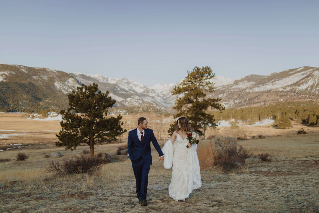 couple holding hands and looking at each other for elopement pictures at Rocky Mountain National Park