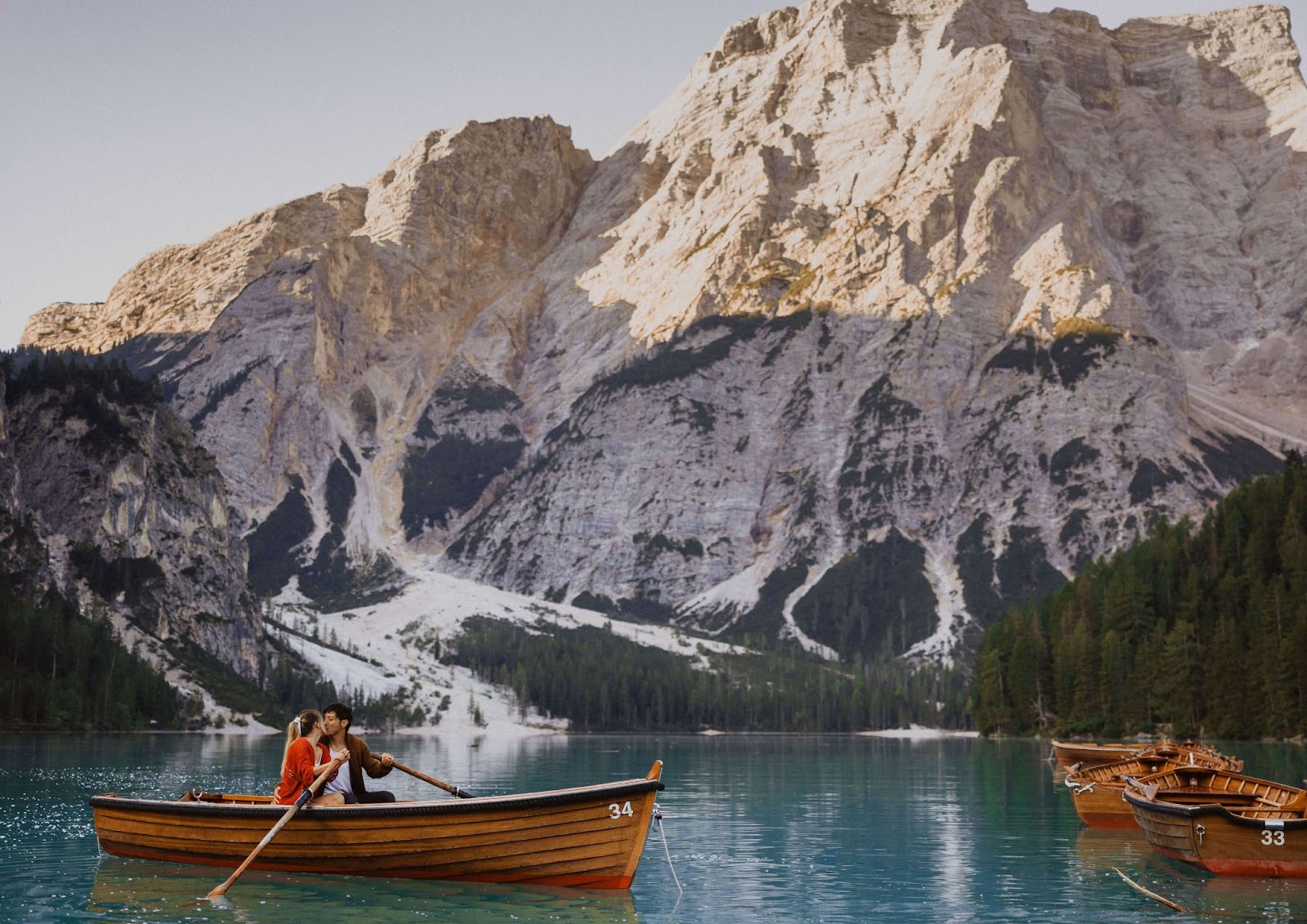 couple kayaking in the Dolomites surrounded by mountains