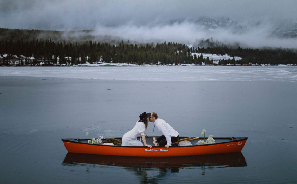 elopement couple kissing in kayak