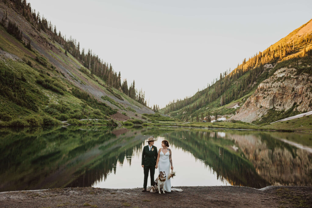 elopement couple posing in valley in Crested Butte, Colorado with dog