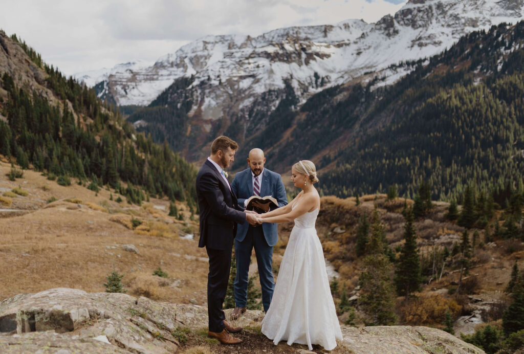 bride and groom at wedding ceremony by mountains in Ouray, Colorado