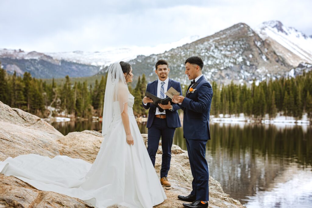 Bride and groom reading vows at Rocky Mountain National Park for elopement