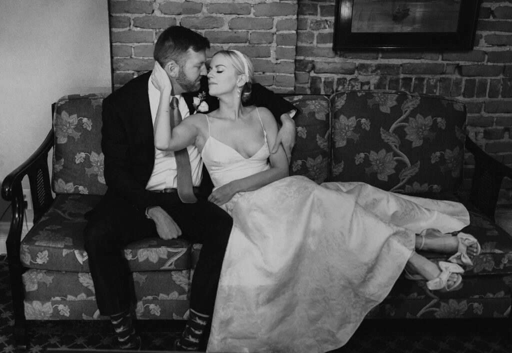 bride and groom posing on couch