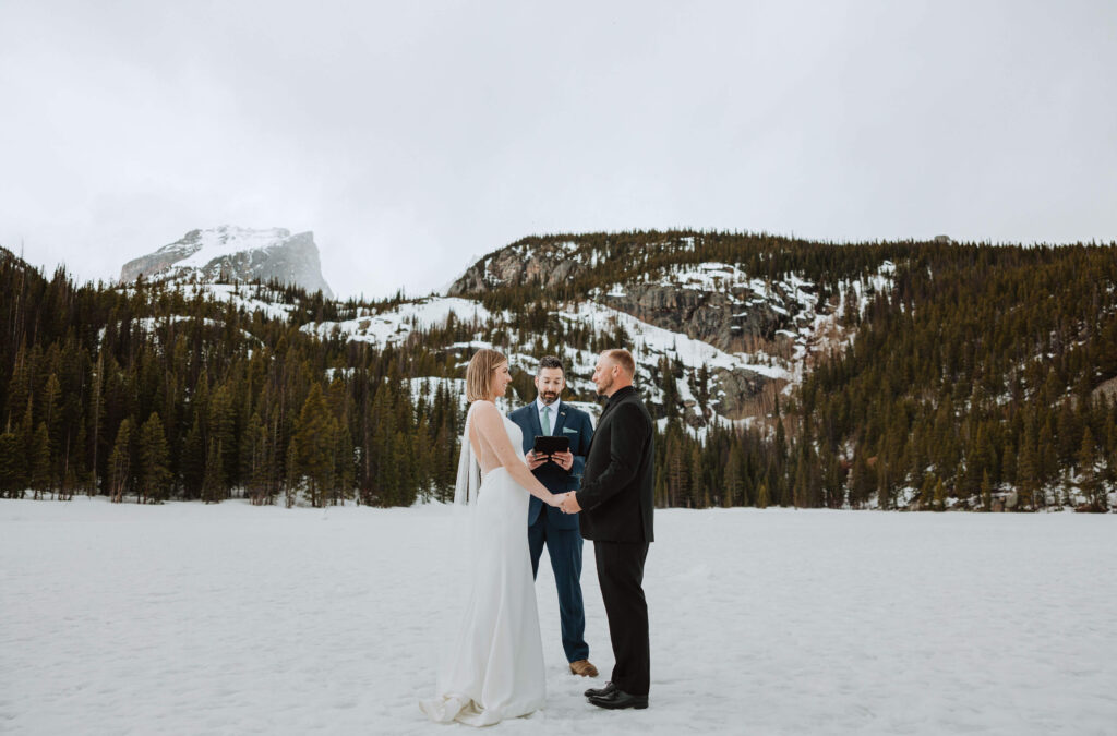 bride and groom at wedding ceremony at Bear Lake Trail in Rocky Mountain National Park
