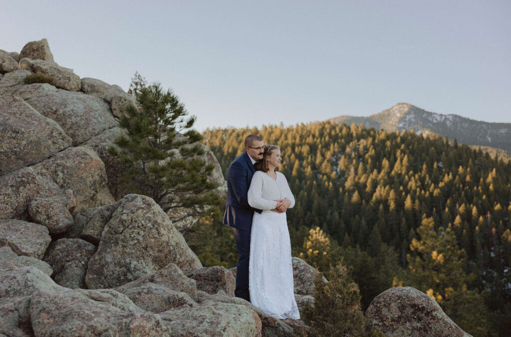 bride and groom posing at May's Point in Boulder