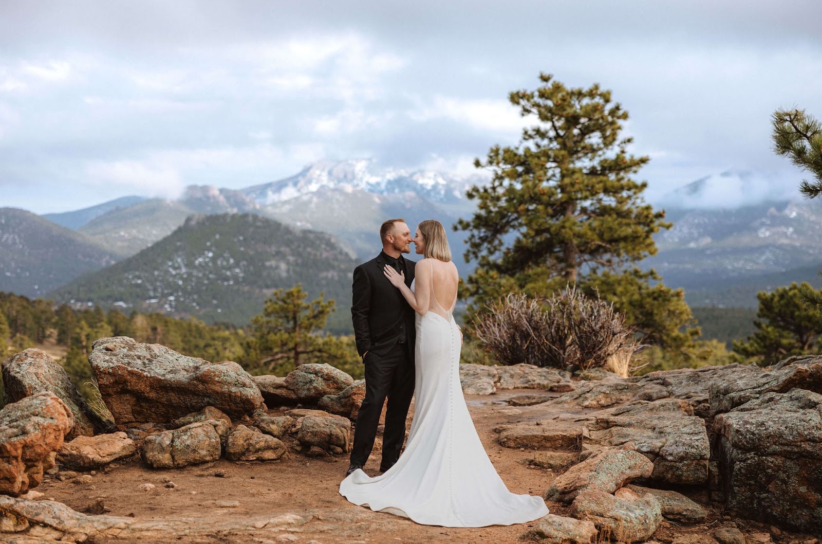 bride and groom posing at 3M Curve in Rocky Mountain National Park