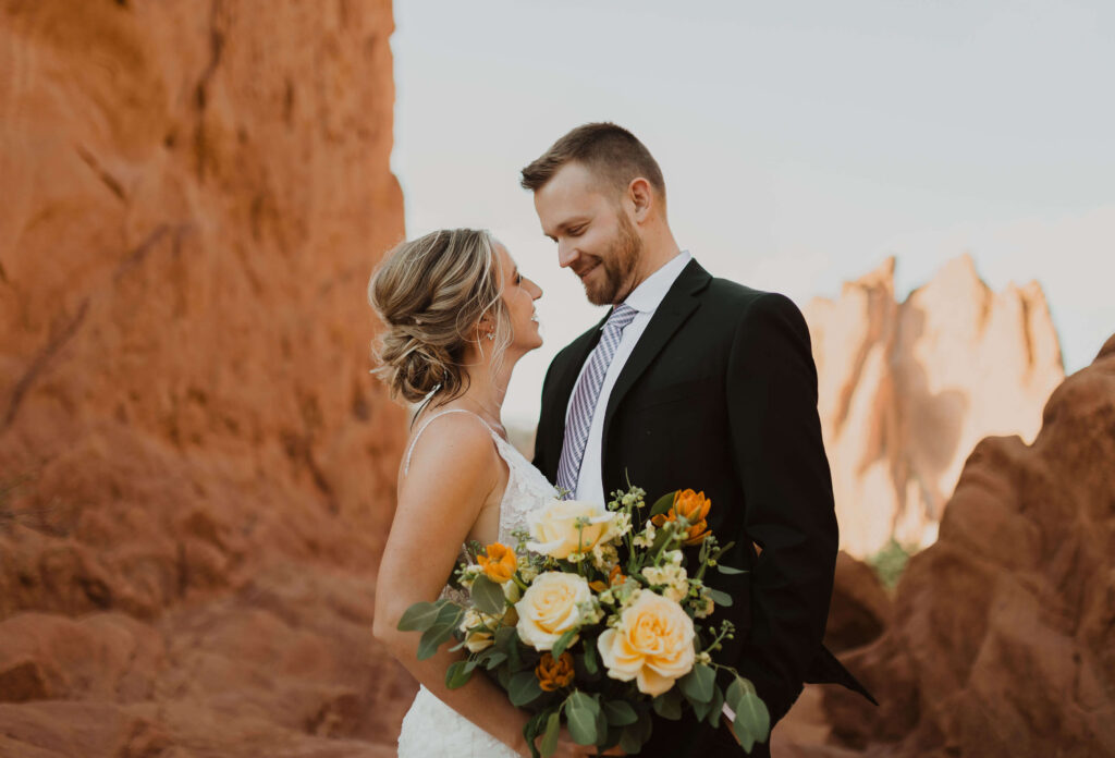 bride and groom posing at Garden of the Gods in Colorado