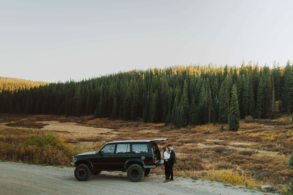 couple posing with jeep for adventure elopement 