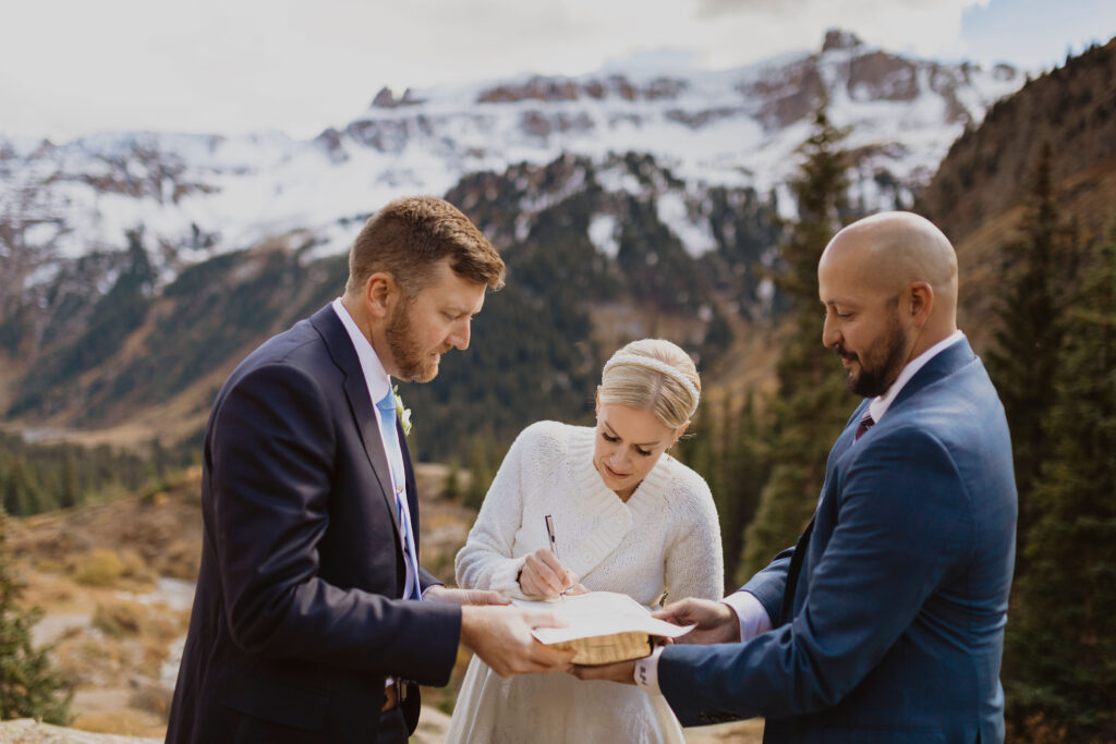 bride signing marriage license to self-solemnize Colorado marriage