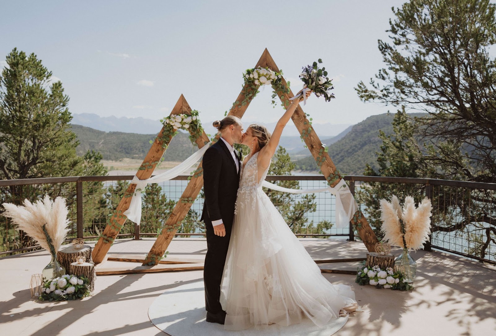 bride and groom kissing at Ridgway State Park is Colorado backed by mountains