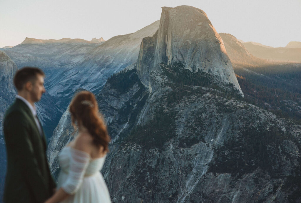 bride and groom looking out at mountains at Glacier Park