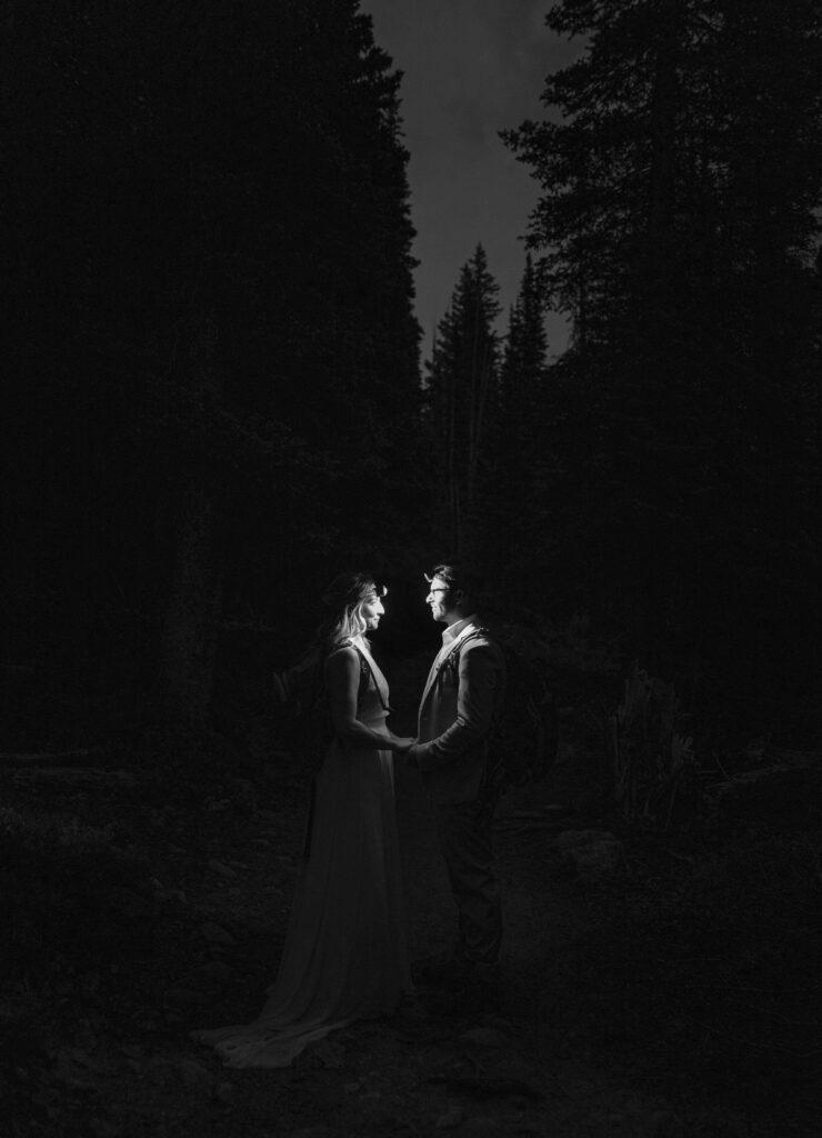 bride and groom in the dark with head lamps