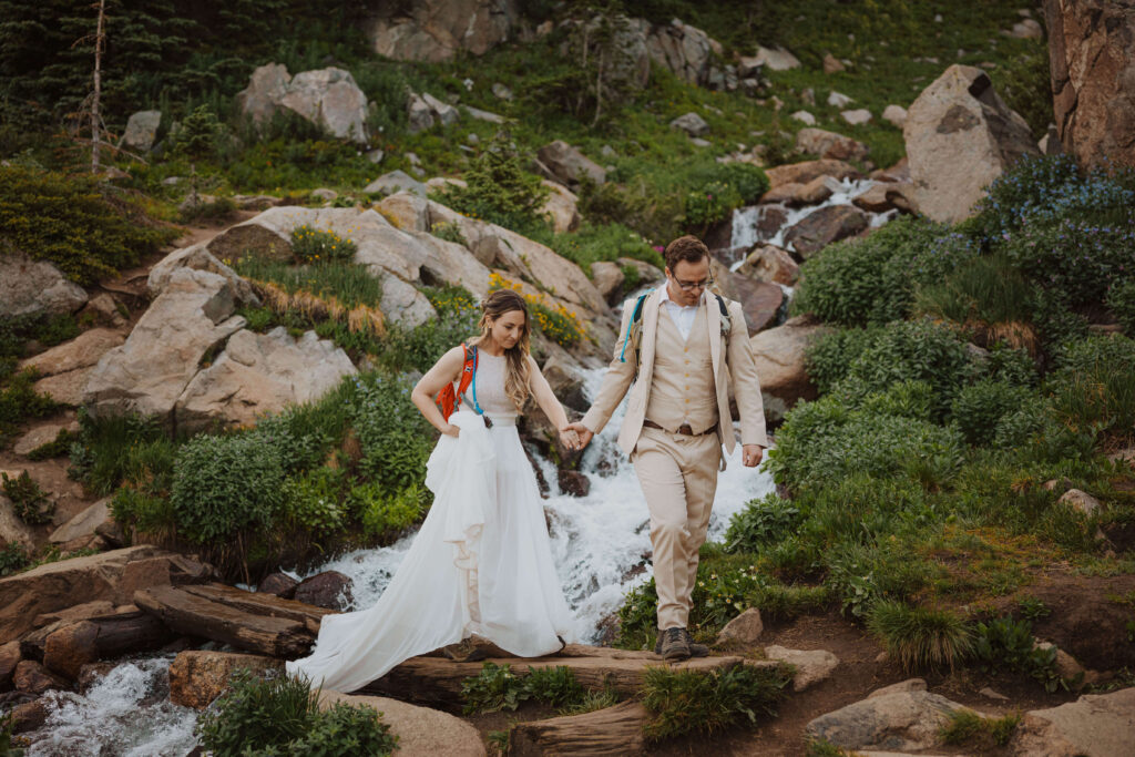 bride and groom walking at Lake Isabelle