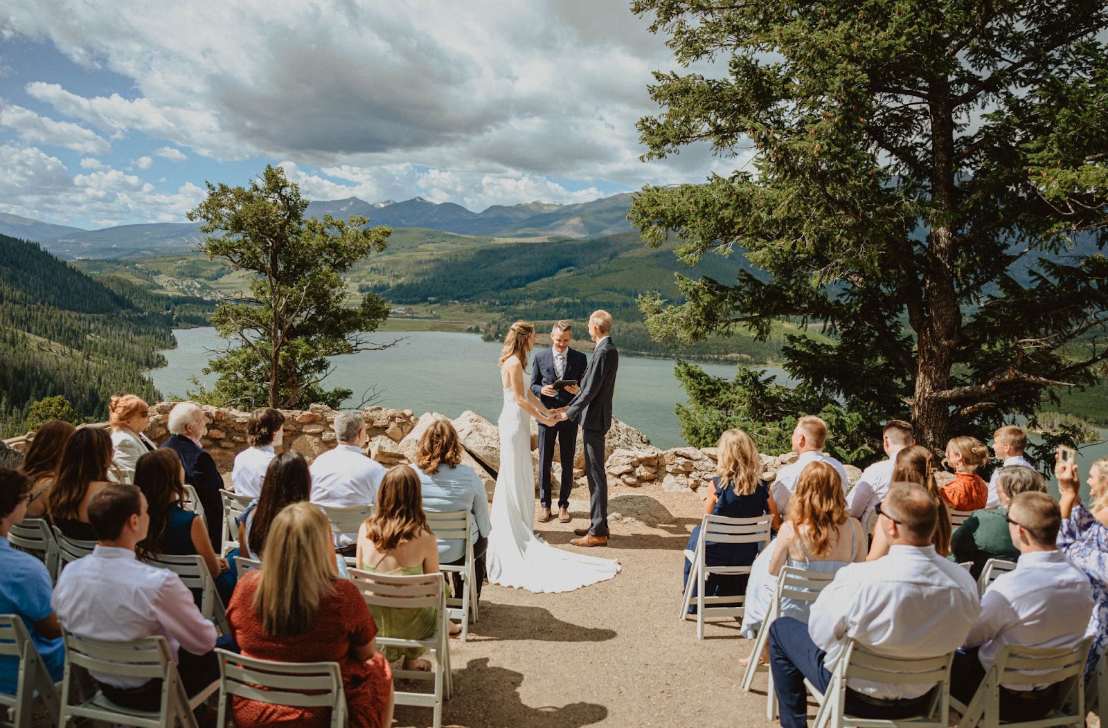 bride and groom with picnic looking at trees 