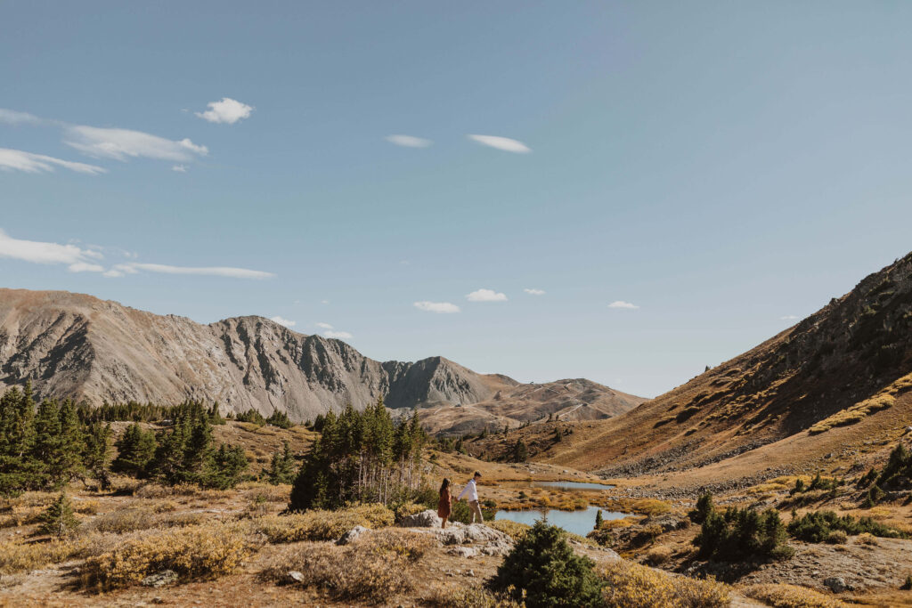 Couple walking in the distance at Loveland Pass for Colorado engagement photos