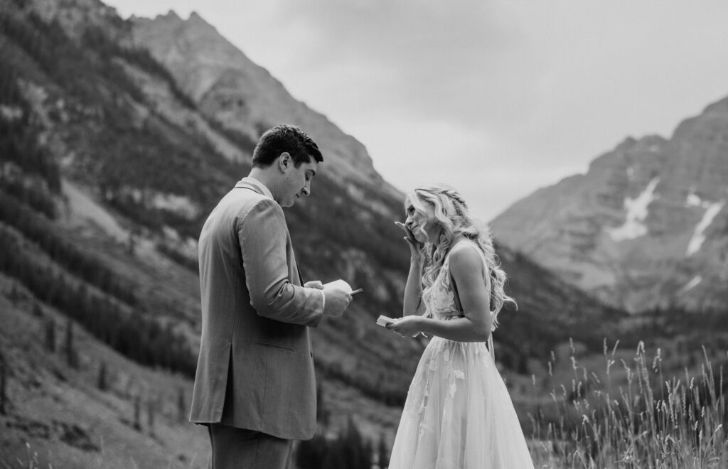 Groom reading vows to bride at Maroon Bells wedding