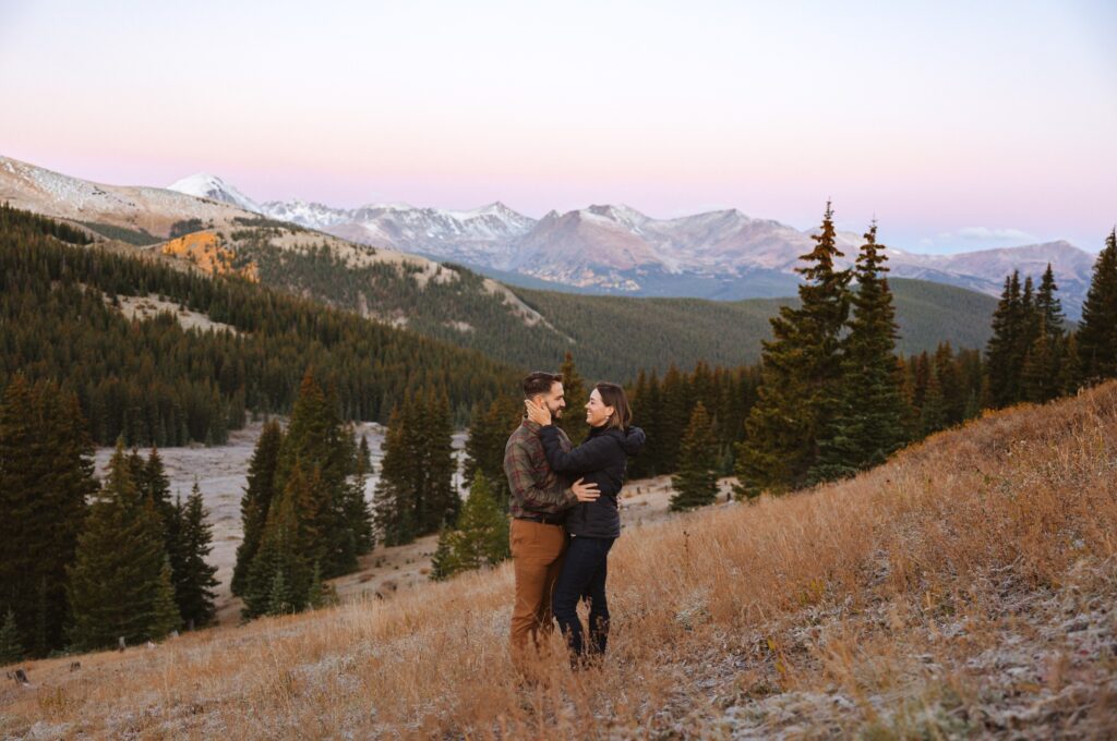 couple posing surrounded by mountains in Breckenridge, Colorado