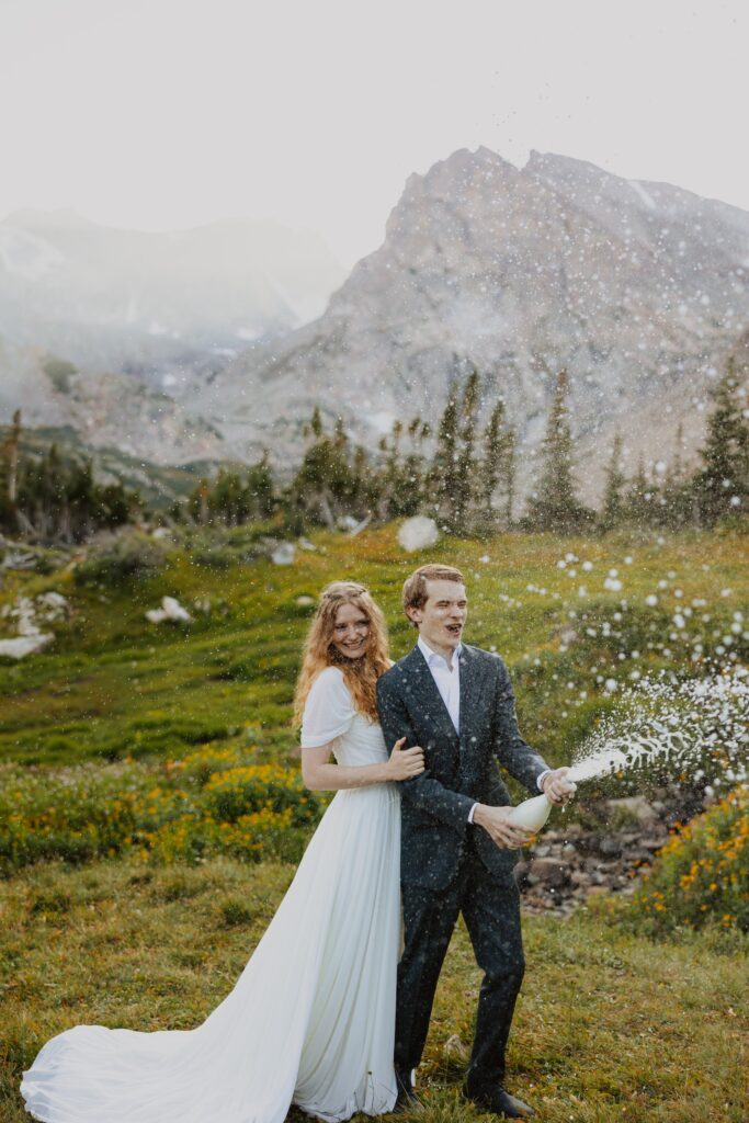 couple with champagne at elopement in Colorado