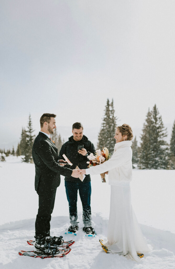 bride and groom at elopement ceremony surrounded by snow in Breckenridge, Colorado