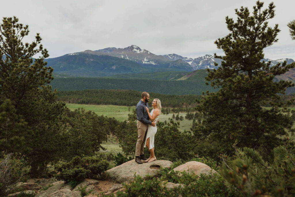 bride and groom at Rocky Mountain National Park backed by greenery and mountain scenery