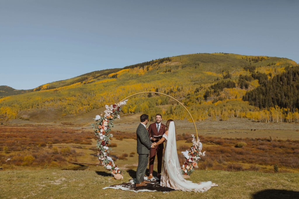 Bride and groom exchanging vows at Cement Creek Ranch