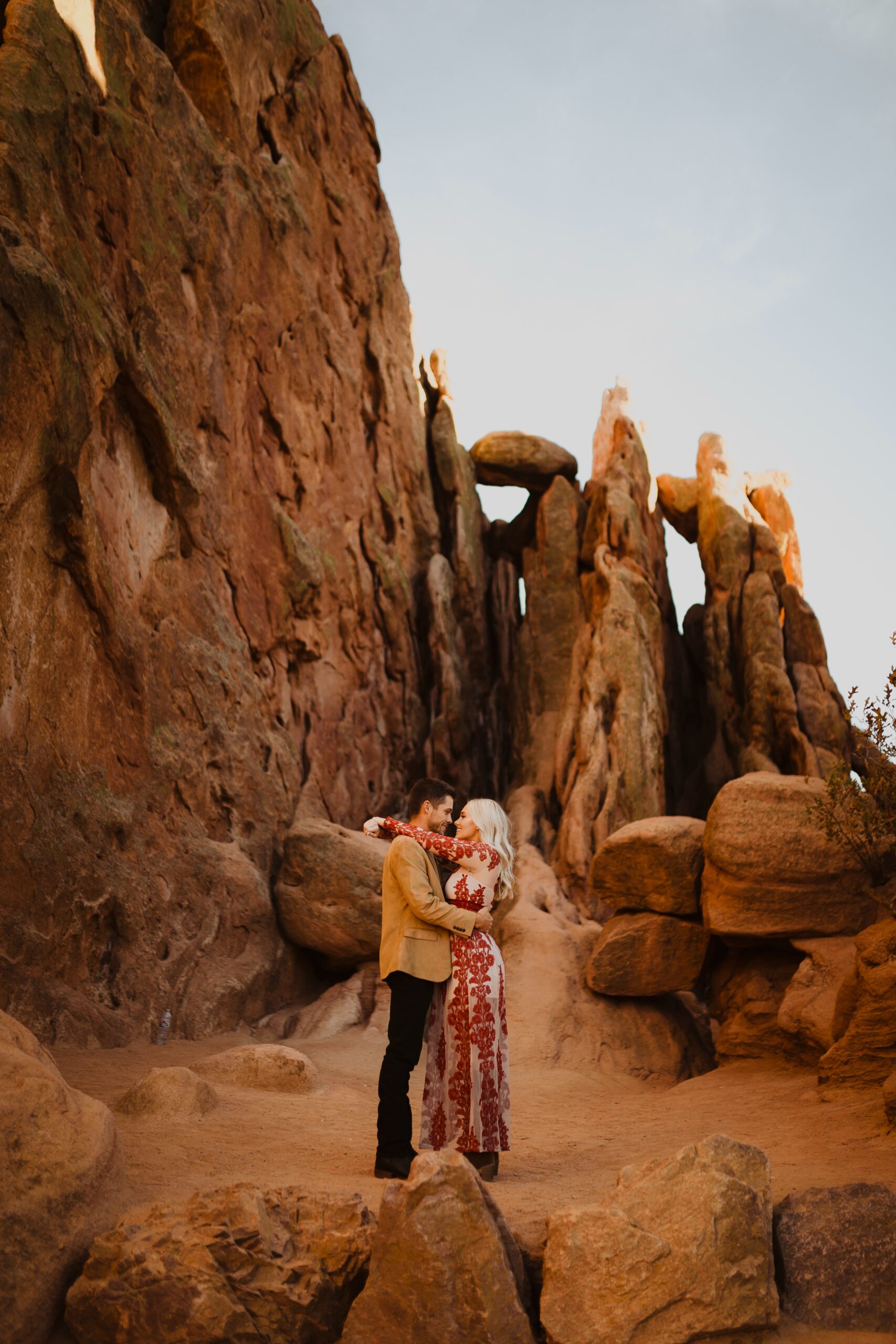 Couple posing for Garden of the Gods engagement photos surrounded by red rock formations