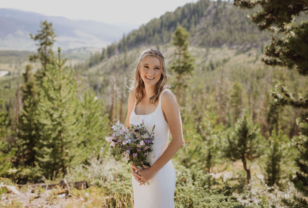 Bride posing at Sapphire Point Overlook holding flowers