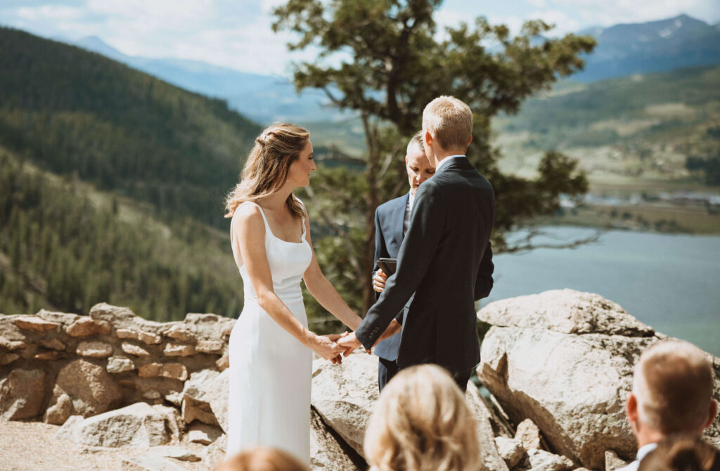 Bride and groom holding hands for vows at Sapphire Point Overlook