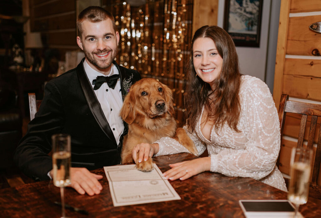 couple signing marriage license with dog