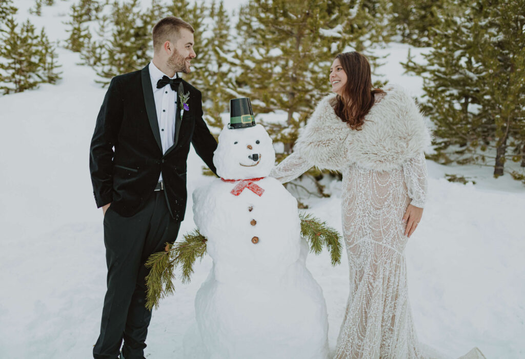 bride and groom with snowman at Sapphire Point Overlook