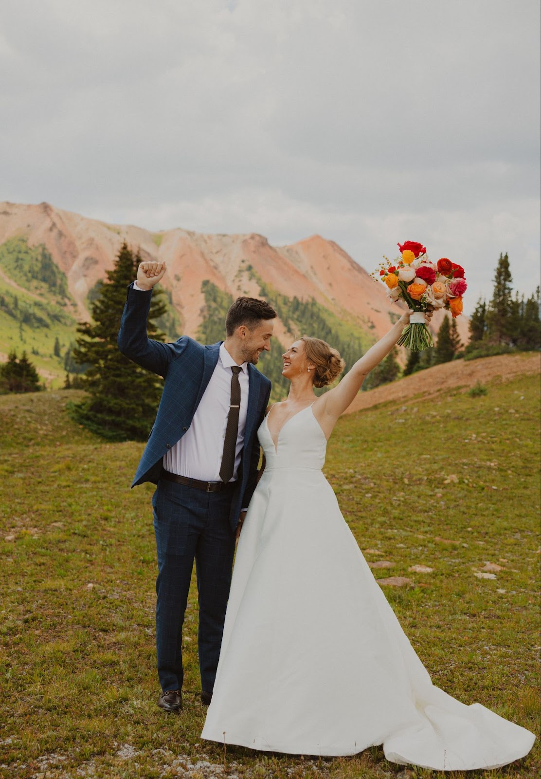 bride and groom smiling at each other backed by mountains for San Juan Mountains elopement