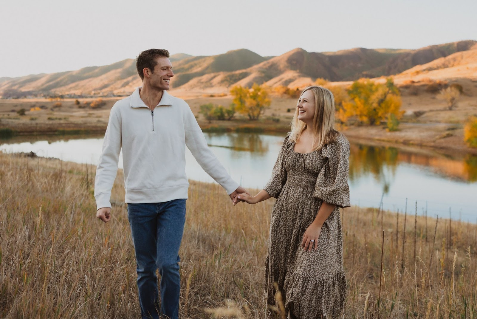 Couple posing and smiling for engagement photos