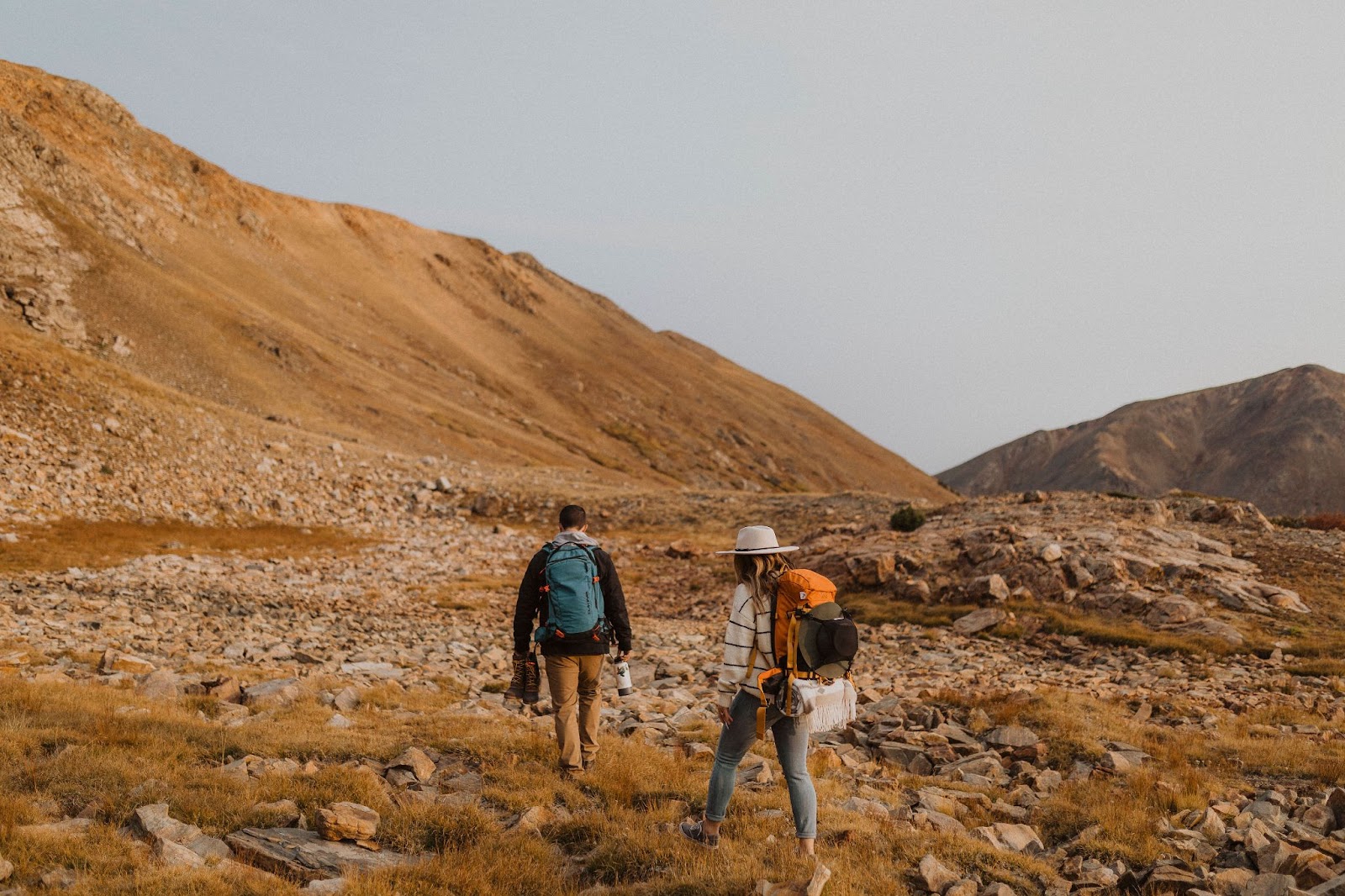 Couple wearing hiking clothes for adventure engagement session