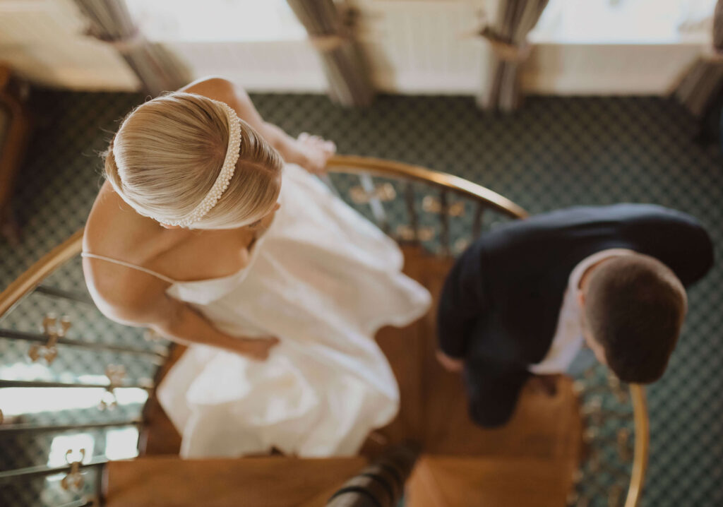 Bride and groom walking down stairs