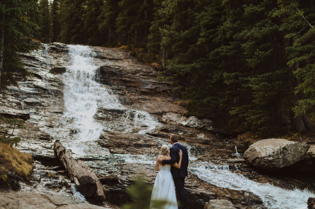 Couple looking at waterfall for San Juan Mountains elopement