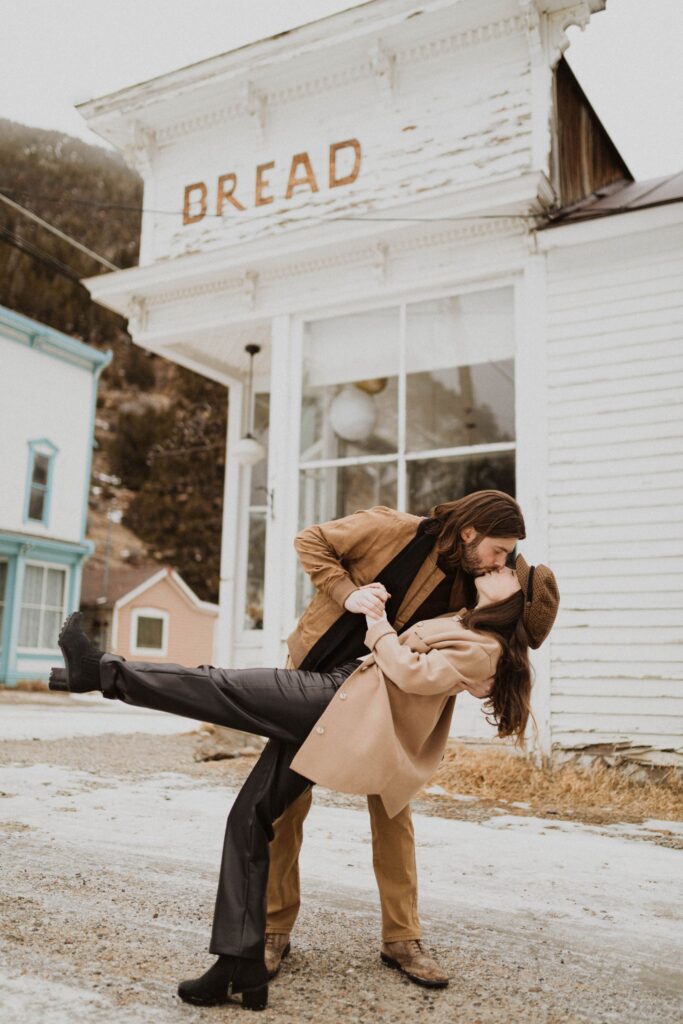 couple in the street kissing and posing for engagement photos