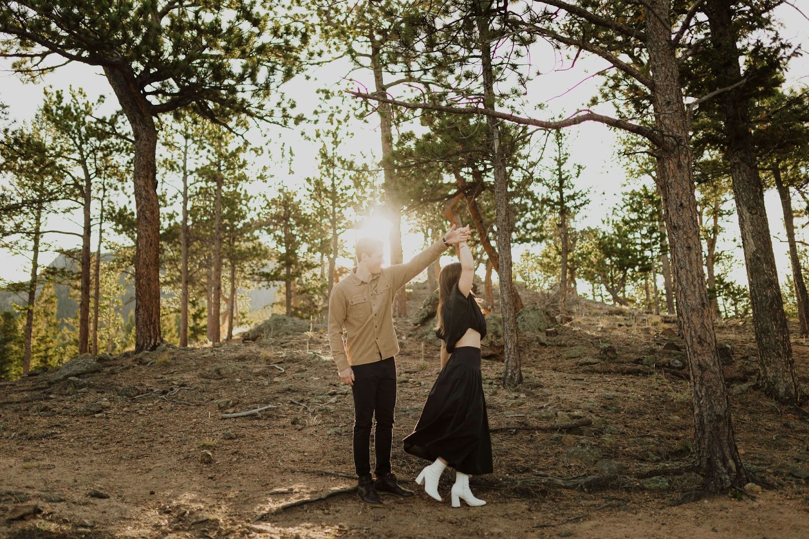 Couple dancing surrounded by trees at Rocky Mountain National Park for engagement photos